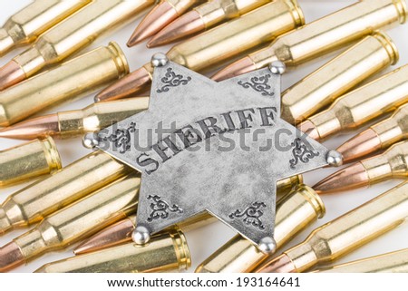 Silver Sheriff star and bullets.