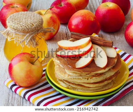 Fresh homemade pancake with apples, honey and cinnamon