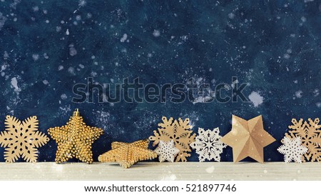 Christmas decoration on the blue vintage background. Paper snowflakes and gold stars. New year greeting card template. Holiday mock up. Scandinavian style.