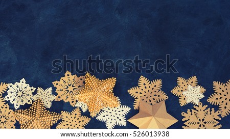 Christmas decoration  on the blue vintage background. Paper snowflakes and golden stars. New year greeting card template. Holiday mock up. Scandinavian style.
