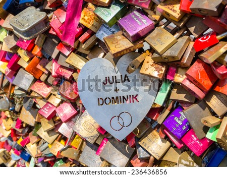 COLOGNE, GERMANY - JUNE 26: To prove their love, couples fix padlocks to the railings of Hohenzollern Bridge in Cologne, to ensure it is everlasting they throw the key into the river below.