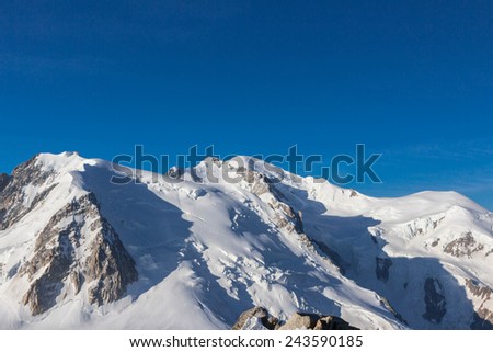 View of the Alps from Aiguille du Midi mountain in the Mont Blanc massif in the French Alps. Summit tourist station in foreground. Alps, France, Europe.