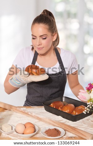 Baking woman smelling a fresh croissant