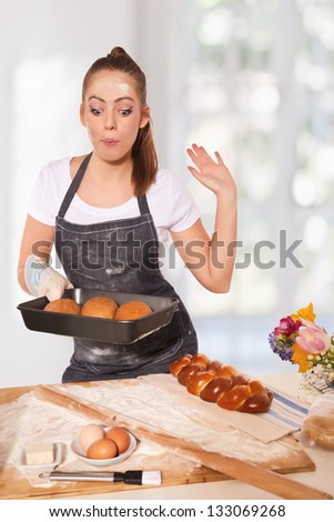 Baking woman admiring a perfect rye loaf