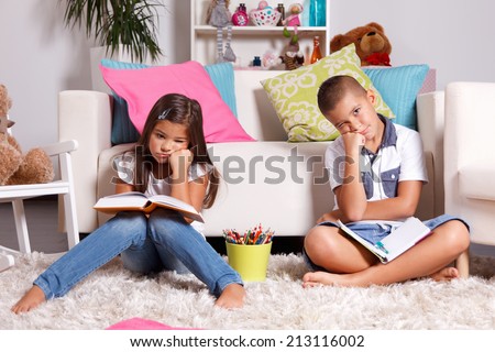 Two young children sick of learning