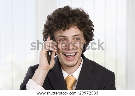 Happy gesturing business man with mobile phone