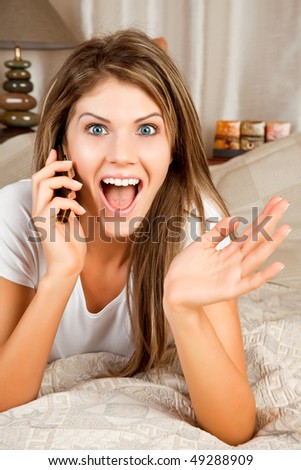 Young beauty woman couch in the bed and telephoning
