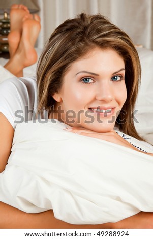 Young beauty woman couch in the bed and smiling