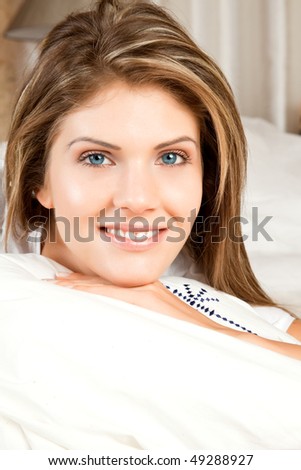 Young beauty woman couch in the bed and smiling