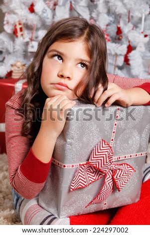 Portrait of a sad little girl at Christmas