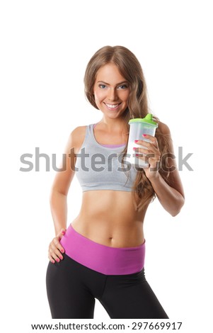 Pretty smiling woman drinking protein shake