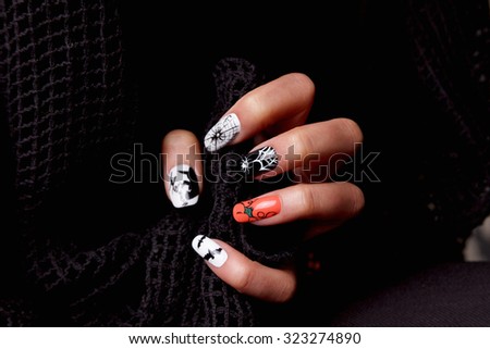 Manicured nails with halloween patterned nail polish