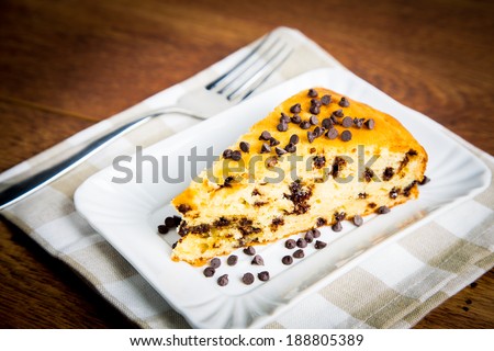 Slice of delicious homemade cake with pears and choco chips on w