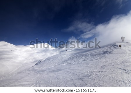 Skier on start of ski slope. Georgia, ski resort Gudauri. Caucasus Mountains. Wide angle view.