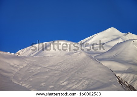 Off-piste slope and blue clear sky in nice winter morning. Ski resort Gudauri. Caucasus Mountains, Georgia.