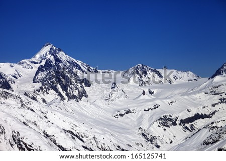 Winter Caucasus Mountains in nice sun day. Georgia, view from ski resort Gudauri.