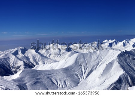 View on off-piste slopes and multicolor blue sky at nice sunny day. Caucasus Mountains, Georgia, ski resort Gudauri.