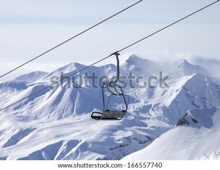 Chair lifts and off-piste slope in fog. Caucasus Mountains, Georgia, ski resort Gudauri.