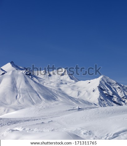 Winter mountains at nice sun day. Caucasus Mountains, Georgia, ski resort Gudauri.