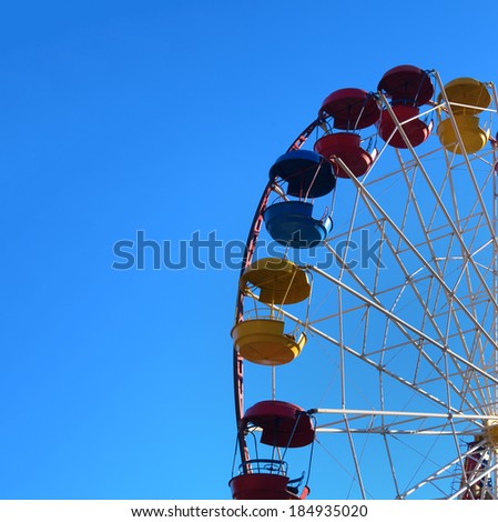 Ferris wheel against blue sky at sun day