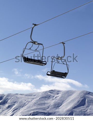Chair lifts and off-piste slope at nice day. Caucasus Mountains, Georgia, ski resort Gudauri.