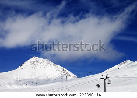 Chair-lift and ski slope at sun day. Caucasus Mountains, Georgia. Ski resort Gudauri.