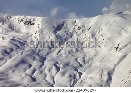 View on off-piste snowy slope  at evening. Caucasus Mountains, Georgia, ski resort Gudauri.