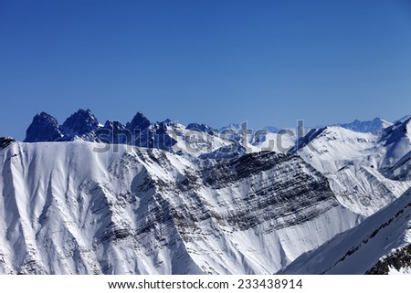 Snowy winter mountains in nice sun day. Caucasus Mountains, Georgia. View from ski resort