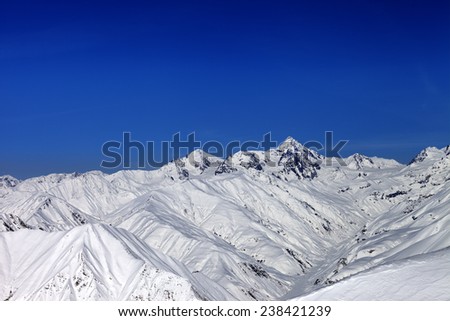 Snowy mountain peaks in sun day. Caucasus Mountains, Georgia. Ski resort Gudauri.