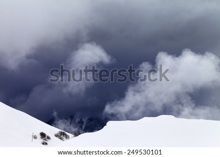 Off-piste slope and storm gray clouds. Caucasus Mountains, Georgia, ski resort Gudauri.