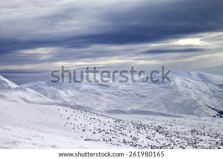 Winter mountains and gray sky. Carpathian Mountains, Ukraine.