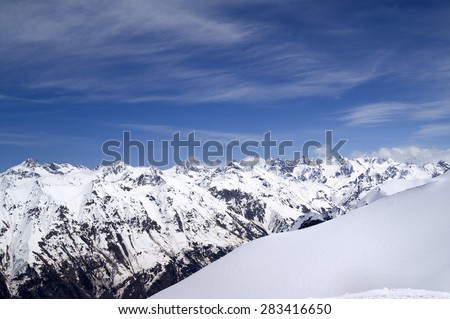 Off-piste slope and snowy mountains. Caucasus Mountains. View from ski resort Dombay on Elbrus region.