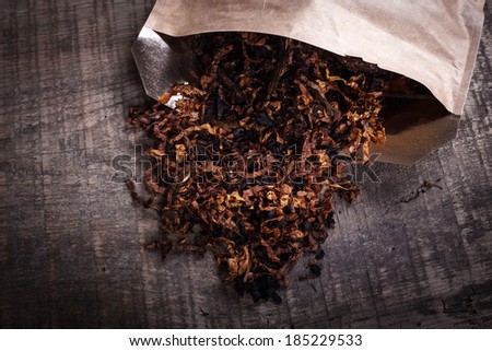 opened package of tobacco on a wooden surface