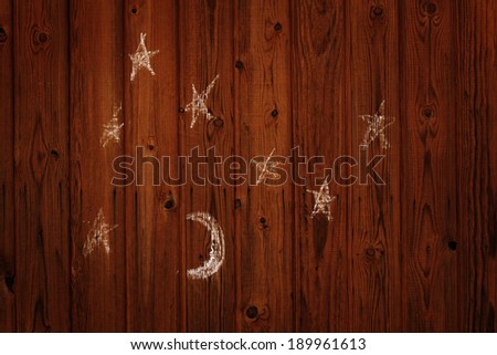 child\'s drawing of the moon and stars on the dark wall