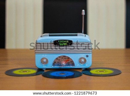 Vintage radio with modern cd\'s which look like long play records.