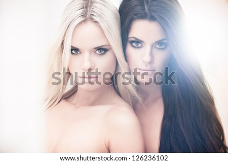 Two beautiful women posing in bleached light