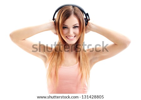 Sexy woman in pink shirt listening for the music using headphones
