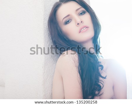 Beautiful brunette lady posing in bleached light