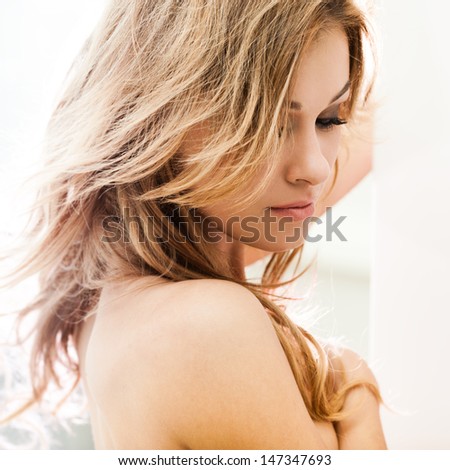 Beautiful brunette lady posing in bleached light