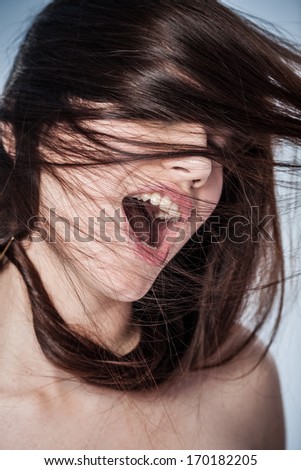 Portrait Of A Young Woman Shouting In Ecstasy