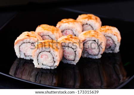 Prawn, soft crab, cucumber and cream cheese rolls served on a plate