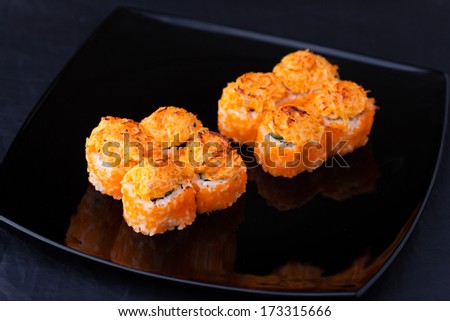 Prawn, soft crab, cucumber and cream cheese rolls served on a plate