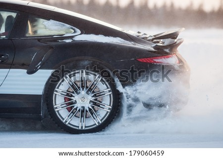 LEVI, FINLAND - FEB 20: Rear wheel spin of a PORSCHE 911 TURBO car during Porsche Driving Experience Snow & Ice Press Event on February 20, 2014 in LEVI, FINLAND
