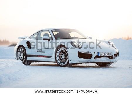 LEVI, FINLAND - FEB 20: Unknown driver drives a PORSCHE 911 TURBO car during Porsche Driving Experience Snow & Ice Press Event on February 20, 2014 in LEVI, FINLAND