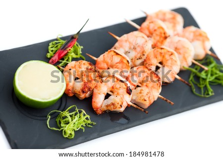 Skewered prawns (yakitori) with sauce isolated on white