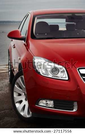 Cherry red car front bumper, light and wheel detail