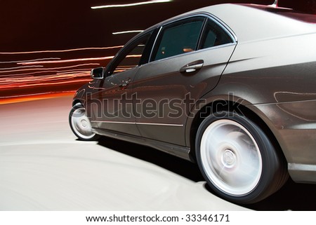 Side view of a car driving fast in the night