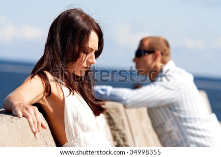 A man and a woman on a pier