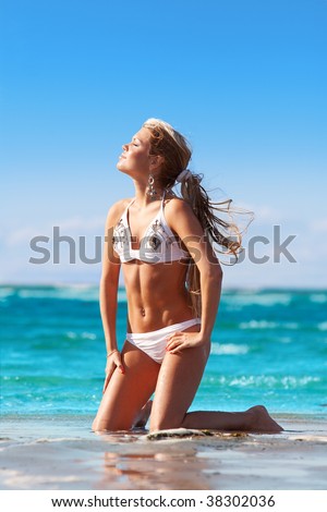 Young girl enjoying sun and water in tropical sea