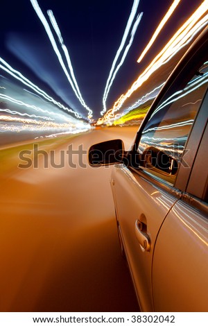 Car driving fast in the night city